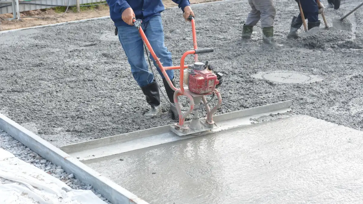 Crew levelling freshly poured concrete
